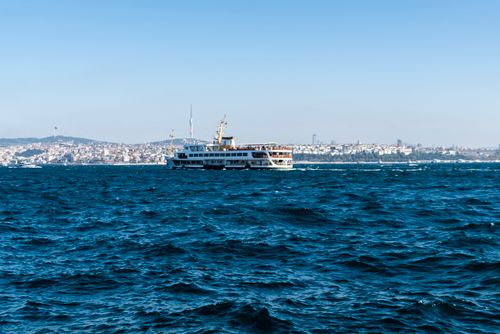 Free A ferry sails across the Bosphorus with Istanbul skyline in view. Stock Photo