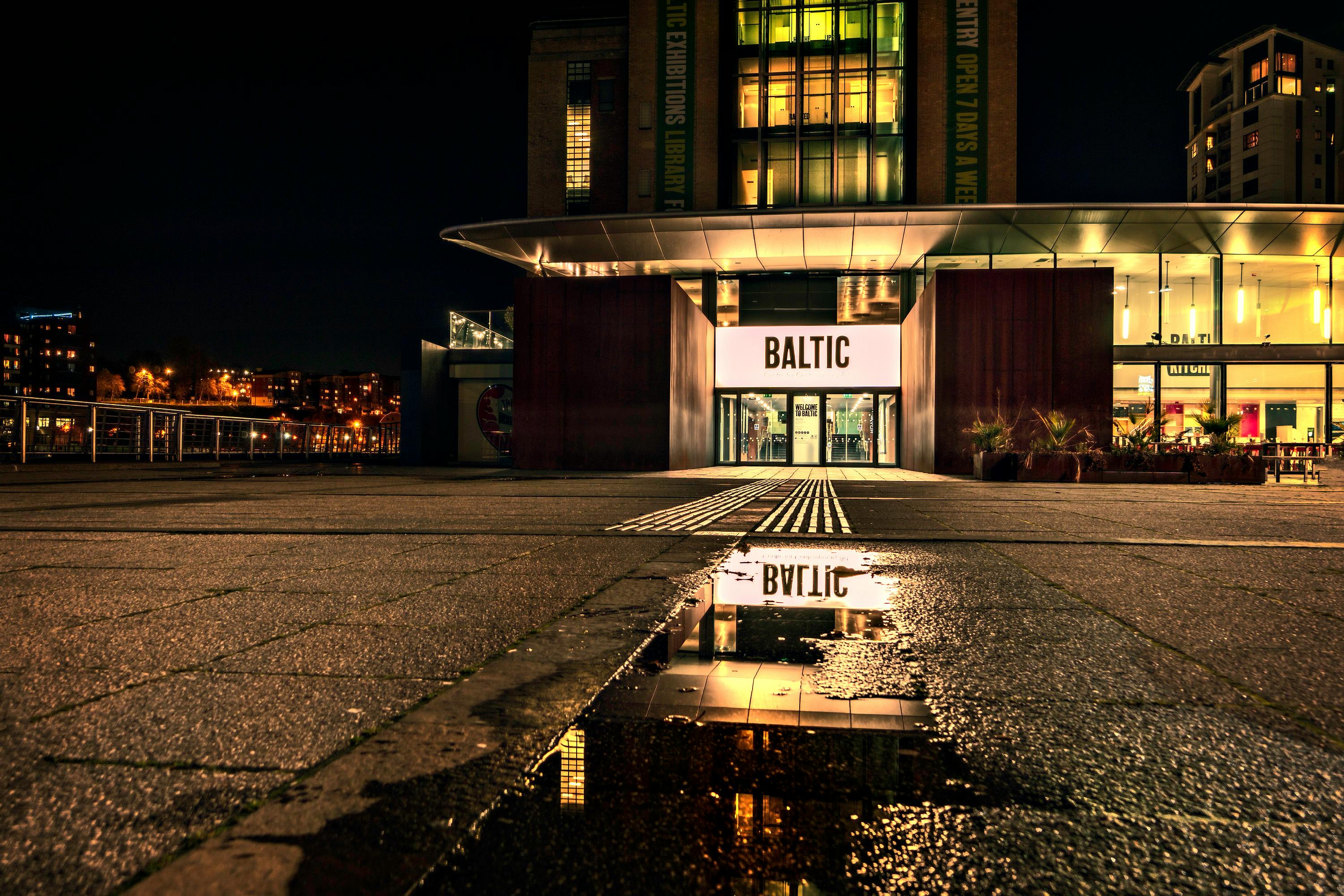 Free Captivating night view of Baltic Center for Contemporary Art with reflections and urban lights. Stock Photo