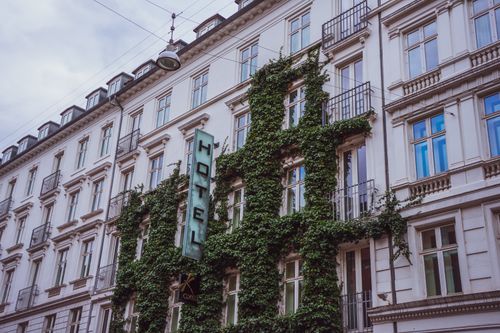 Free Elegant hotel facade covered in lush ivy, located in urban Copenhagen. Stock Photo