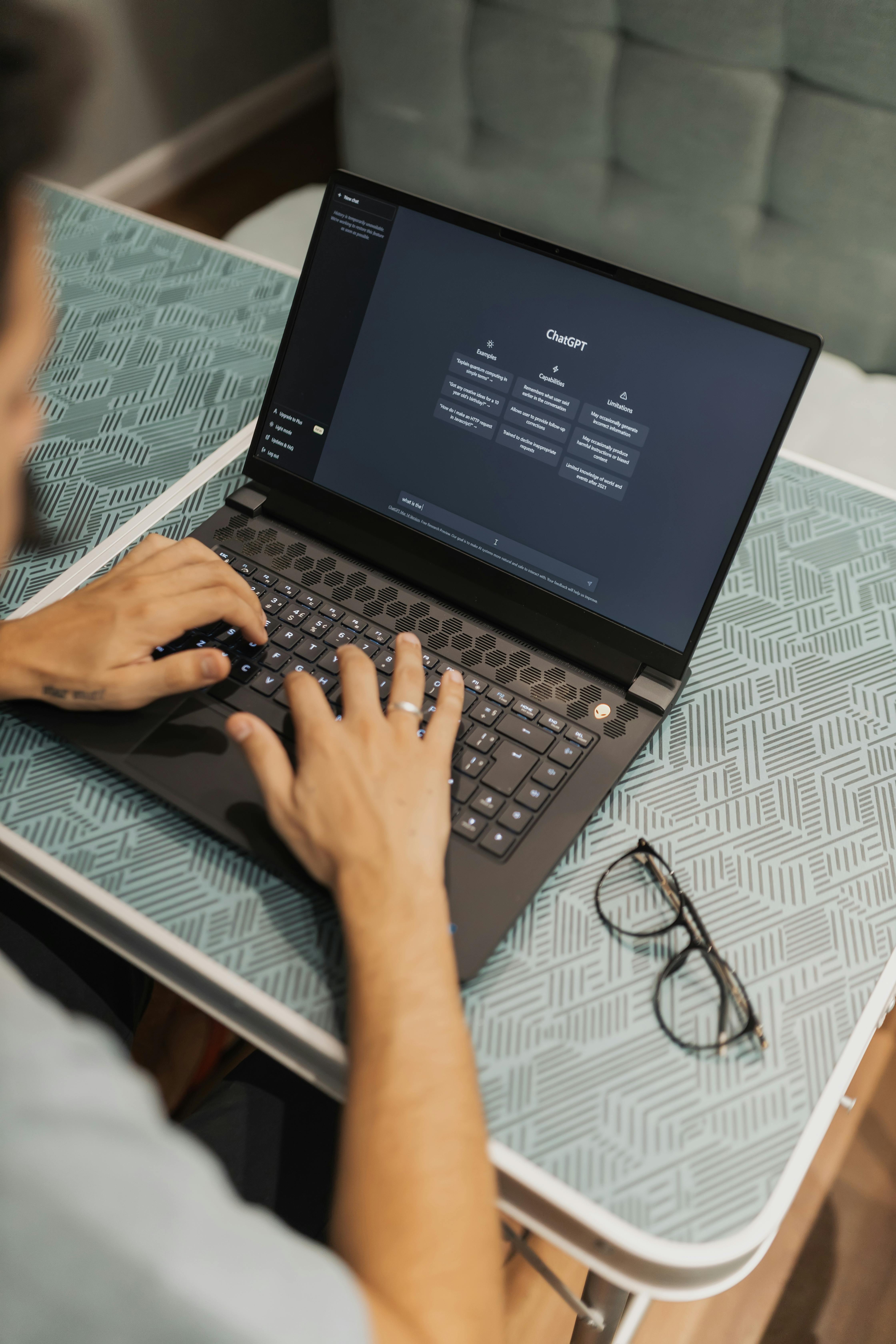 man sitting at cafe table and using laptop with chat gpt