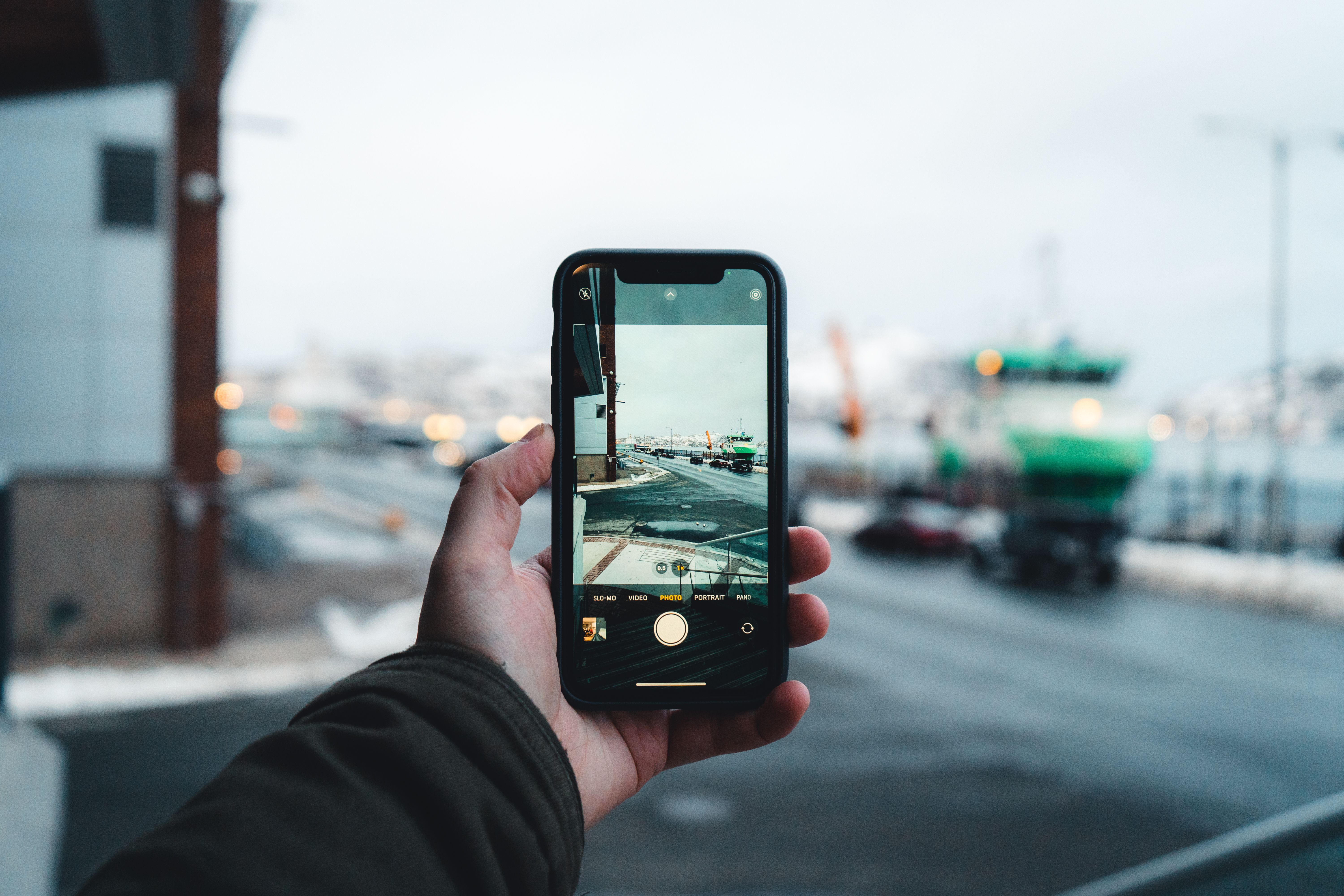 Free Person captures an urban winter scene on a smartphone, focusing on the street view ahead. Stock Photo