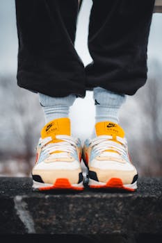 Close-up of Nike sneakers on a ledge, showcasing urban fashion style.