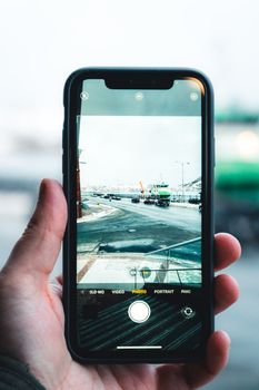 A smartphone captures a bustling city street, showcasing modern wireless technology in photography.