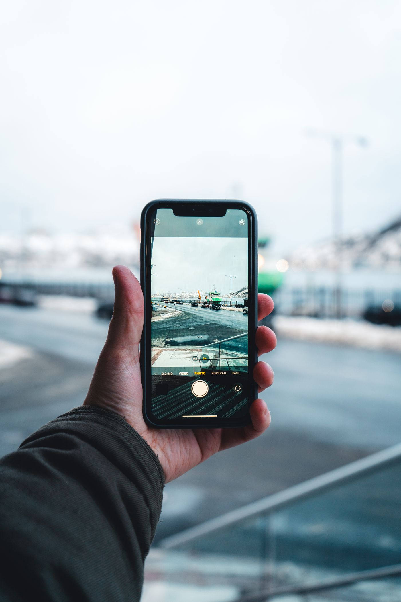 A traveller holding a smartphone on a city street