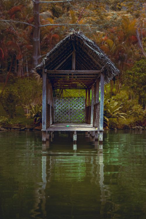 Free A rustic wooden pier with a roof amidst a lush jungle setting in Tarapoto, Perú. Stock Photo