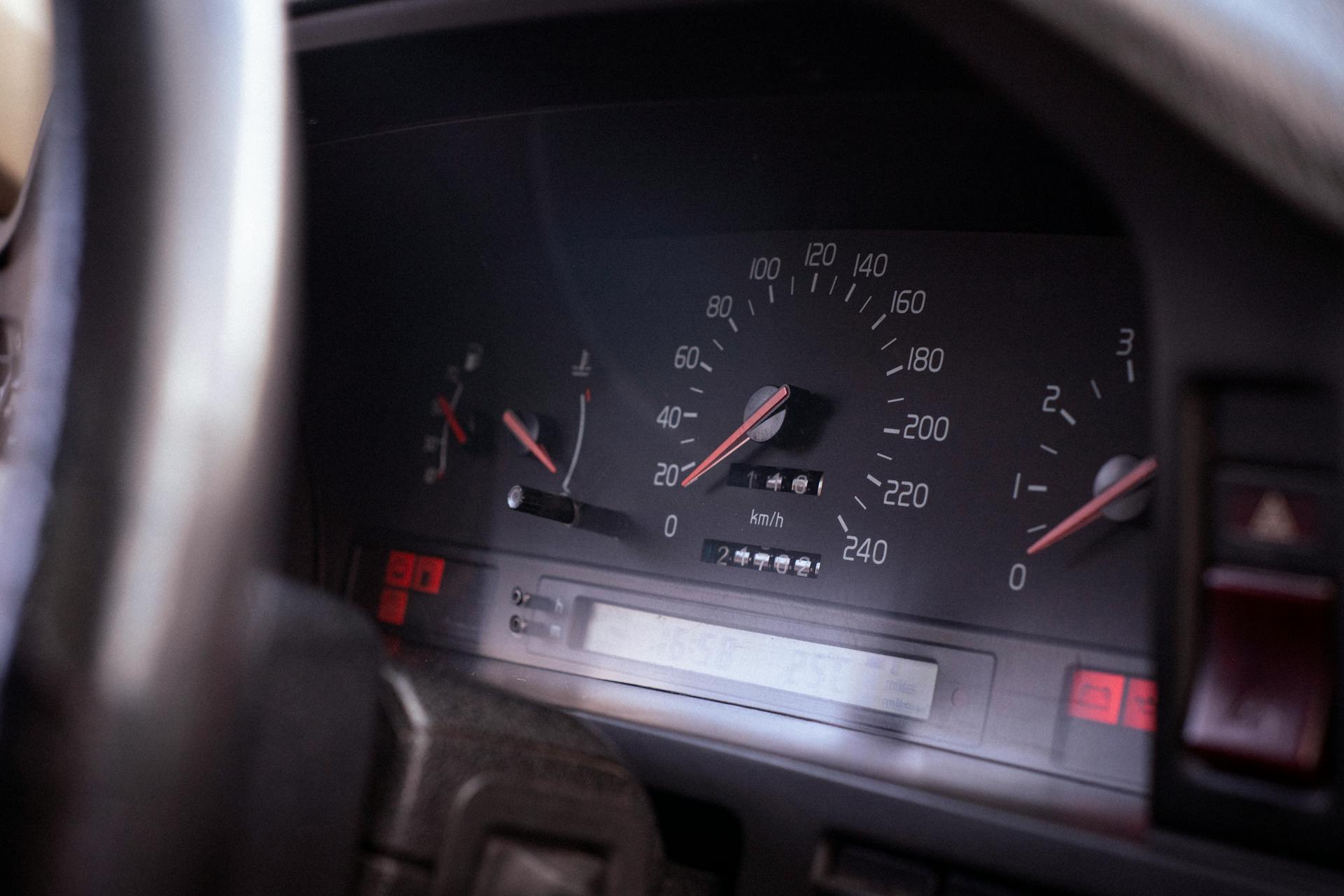 Detailed interior view of a car's speedometer and dashboard gauges, highlighting the speed and control indicators.