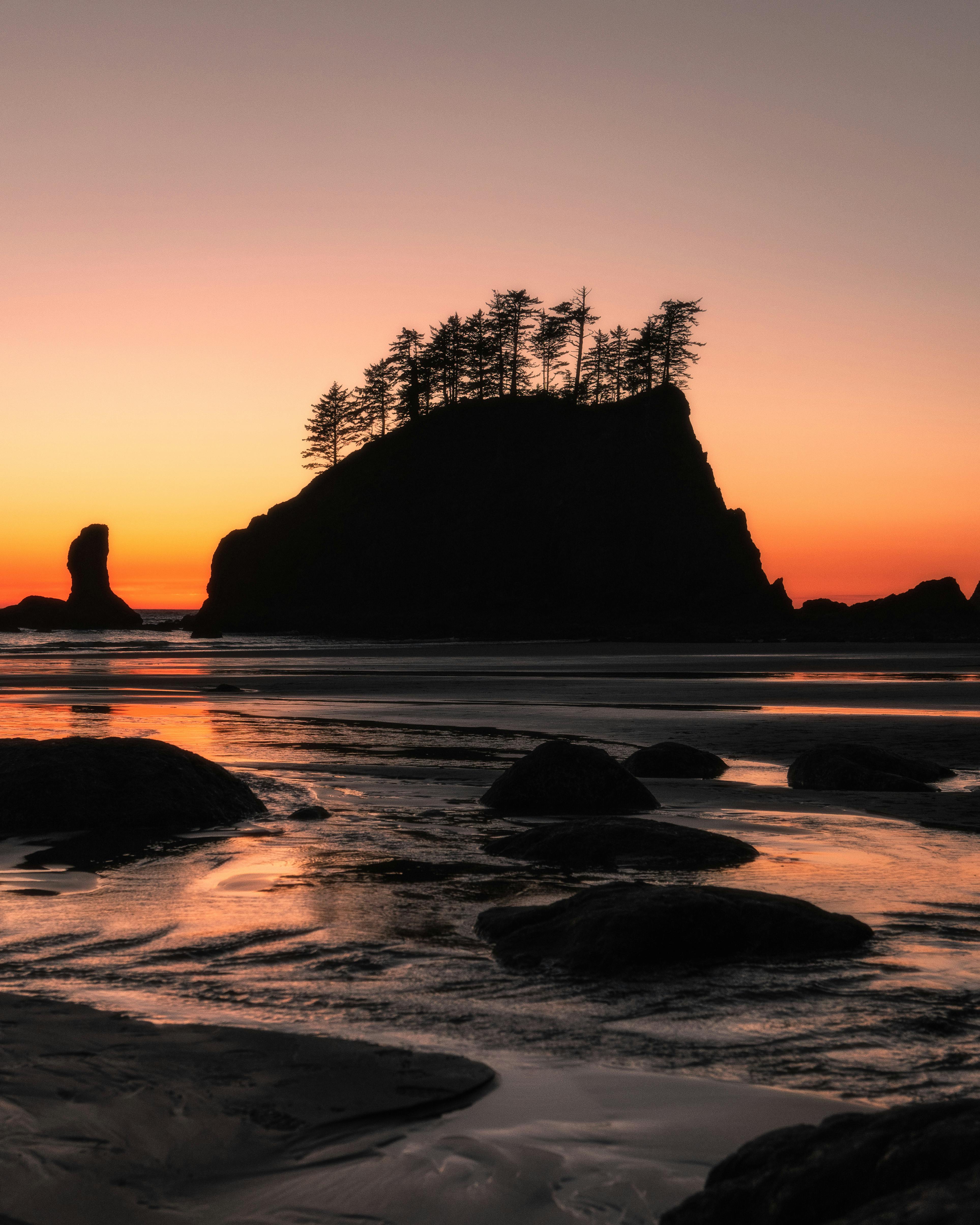 Dramatic sunset with rock formations and silhouettes at La Push, WA.