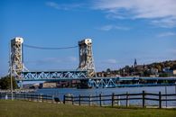 Scenic view of the Portage Canal Lift Bridge in Houghton, Michigan against a clear blue sky.