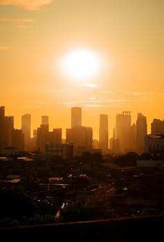 A stunning view of the city skyline during a golden hour sunset, highlighting urban architecture.