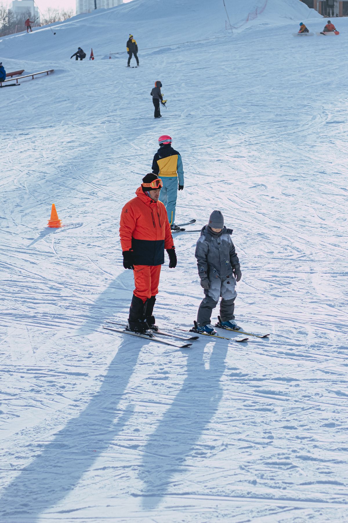 Ski instructor with young child