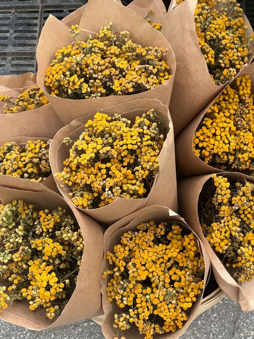 Free Top view of fresh yellow floral bouquets in eco-friendly paper wraps. Stock Photo