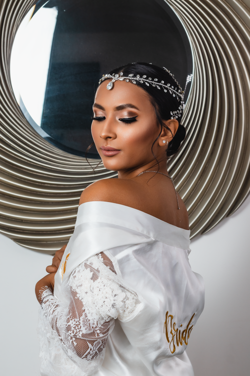 Free Beautiful bride in a white robe adorned with a stylish tiara, posing gracefully. Stock Photo