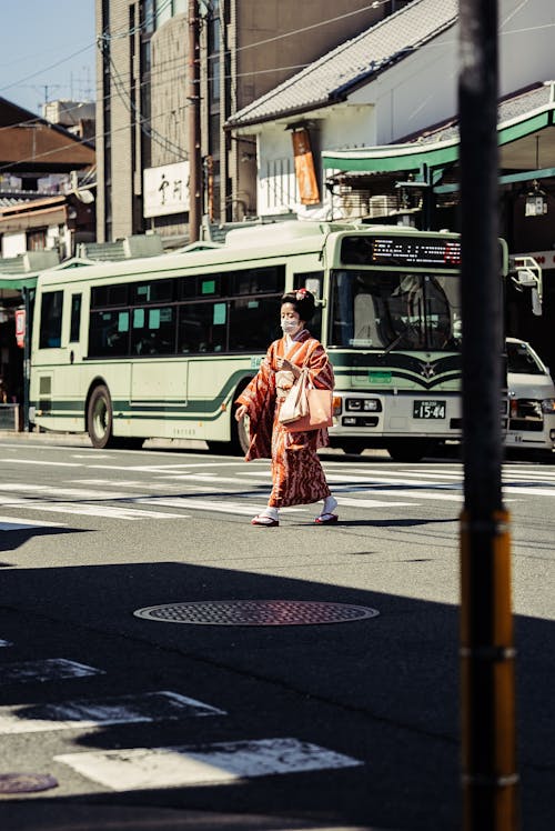View of a Woman in a Kimono Crossing the Street in Kyoto, Japan 