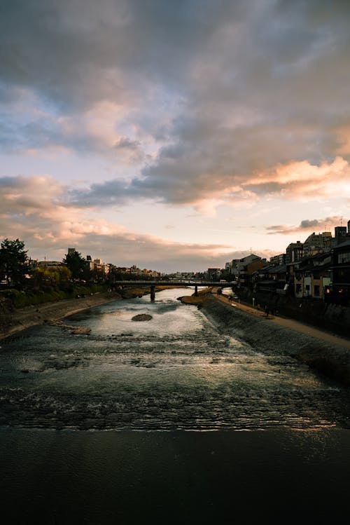 Clouds over River in Town