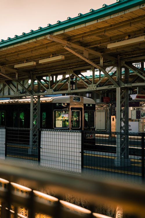 Free A sleek train waiting at a city railway station with industrial architecture. Stock Photo