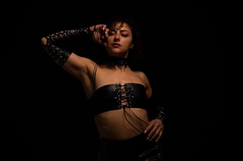 Free Striking studio portrait of a woman posing confidently in leather fashion. Stock Photo