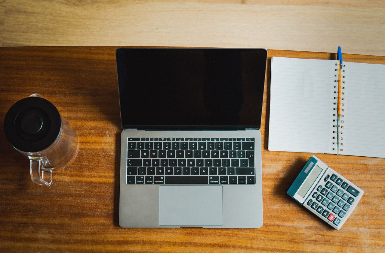 Accountant reviewing figures with a calculator and reports