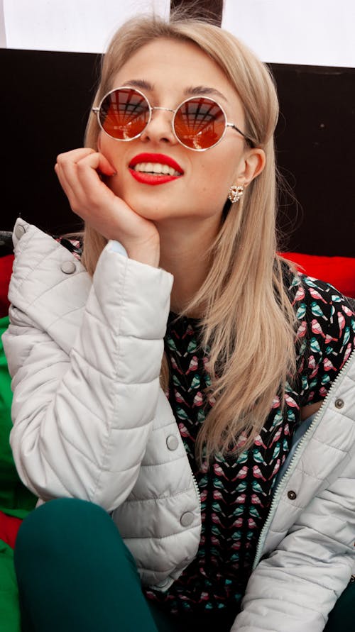 Smiling Woman Sitting with Head Rested on Her Hand