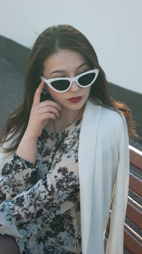 Beautiful Woman in White Jacket and Sunglasses