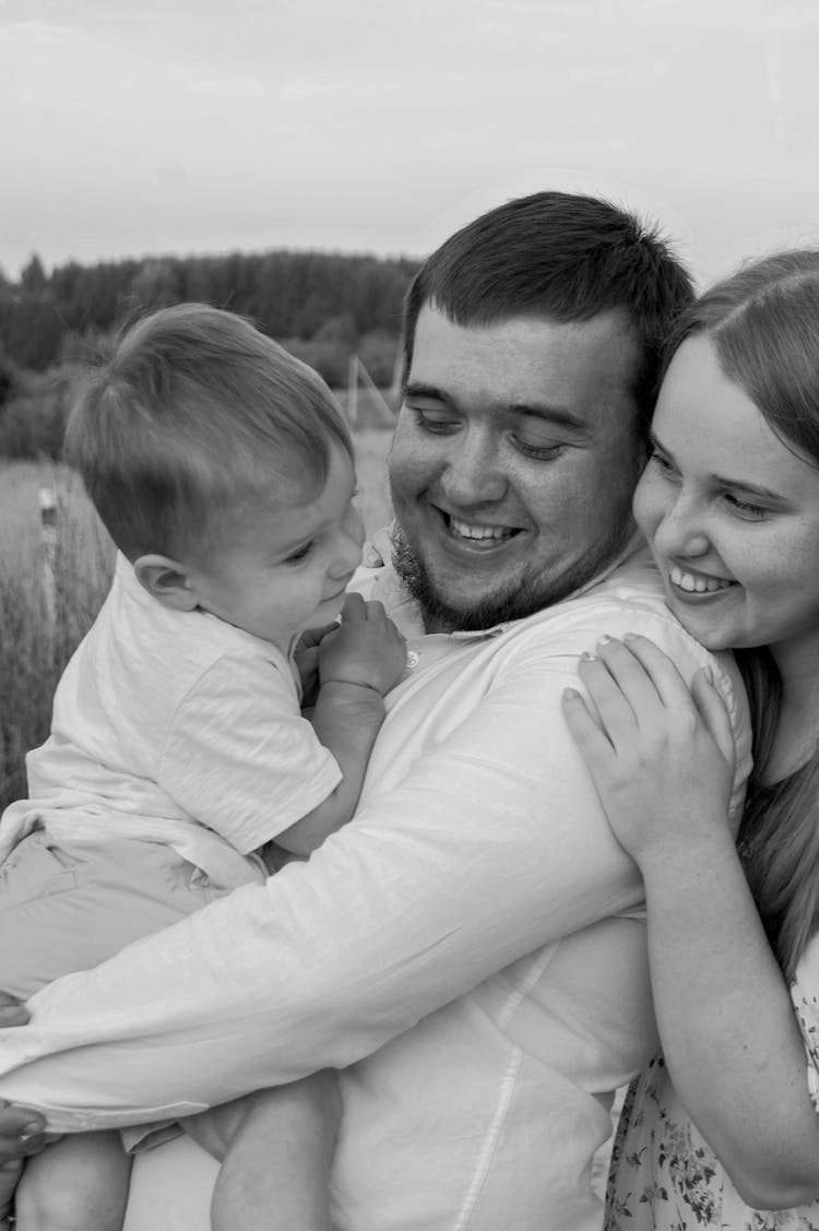 Black And White Photo Of A Couple With A Baby 