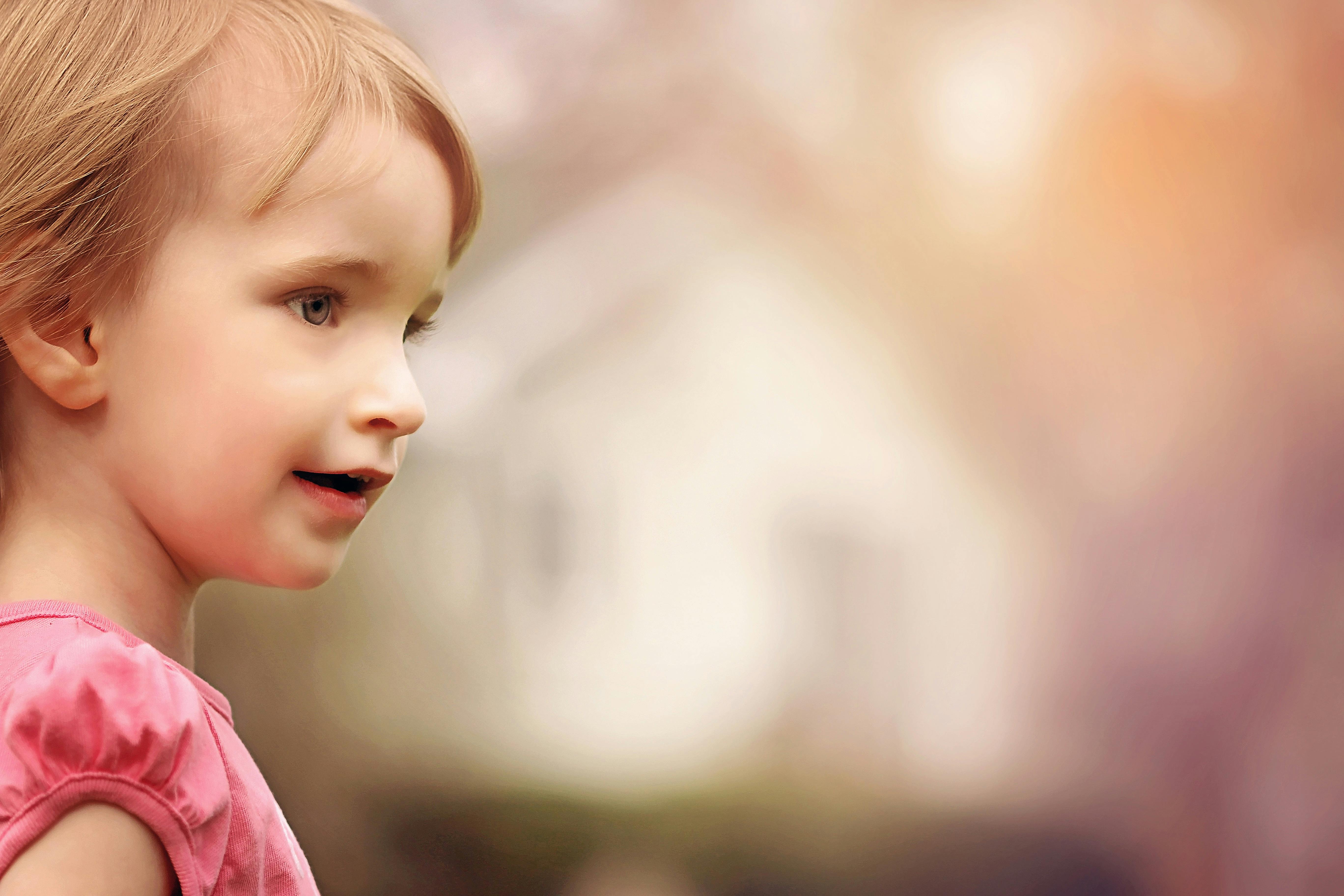 close up photo of girl in pink shirt