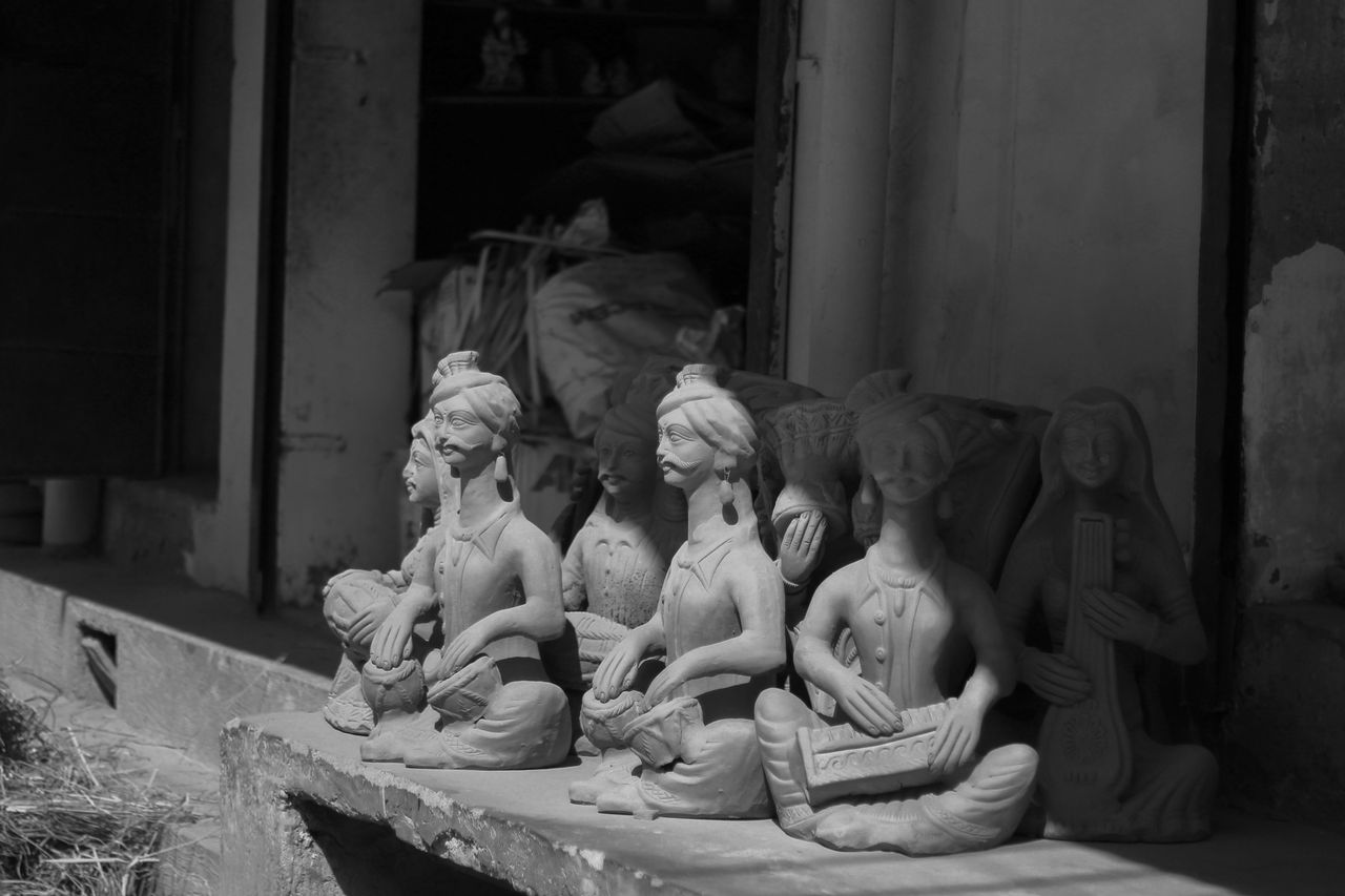 black and white photo of monochrome musician sculptures capturing arti