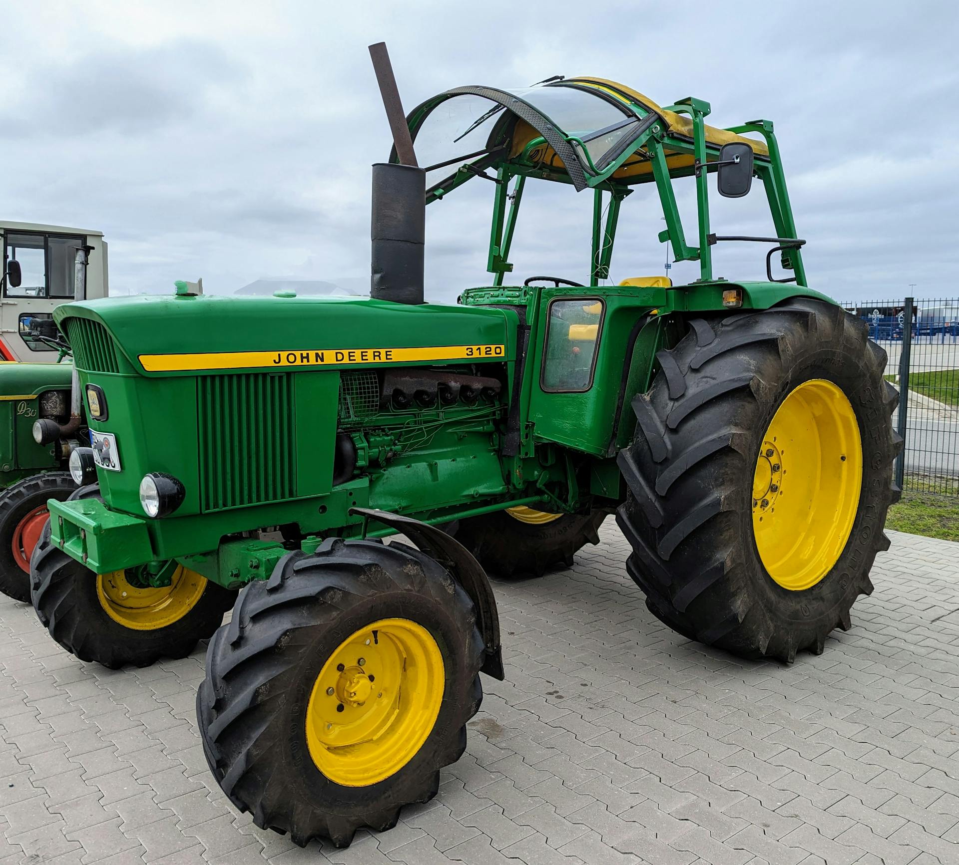 A classic John Deere tractor parked outdoors with clear copy space in Werlte, Germany.