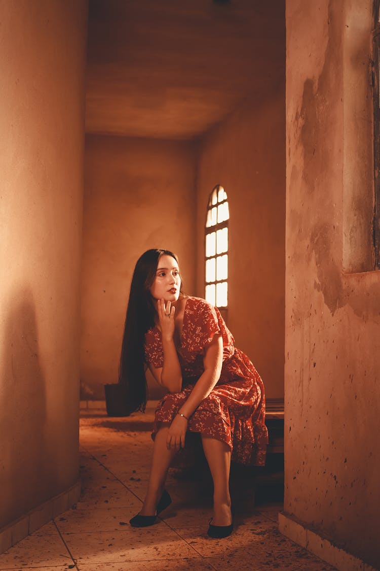 Woman Sitting In An Empty Room 