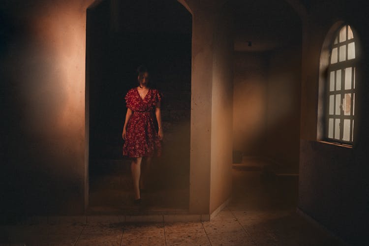 Woman Walking In A Dark Room 