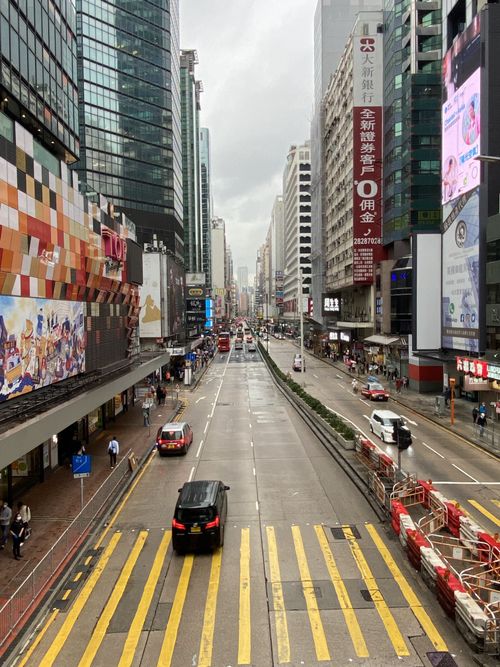 Free High street view with skyscrapers and traffic in a bustling cityscape. Stock Photo