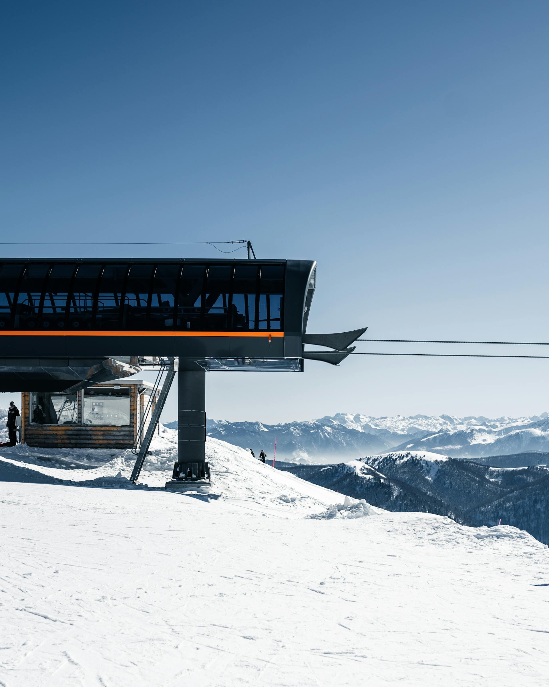 A ski resort with a lift on a snowy mountain with stunning views