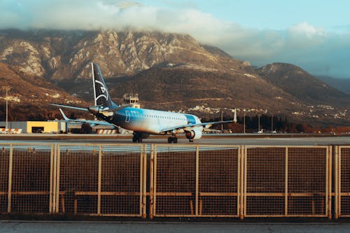 An Airplane at the Airport in Mountains 