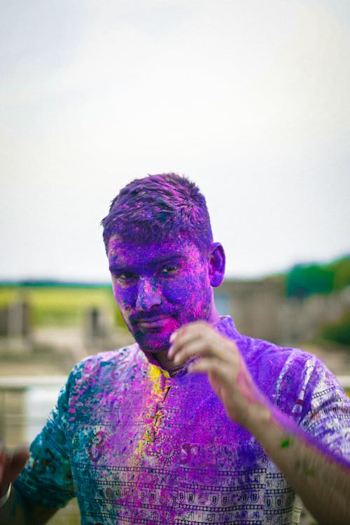 Man with pink powder paint on face hi-res stock photography and