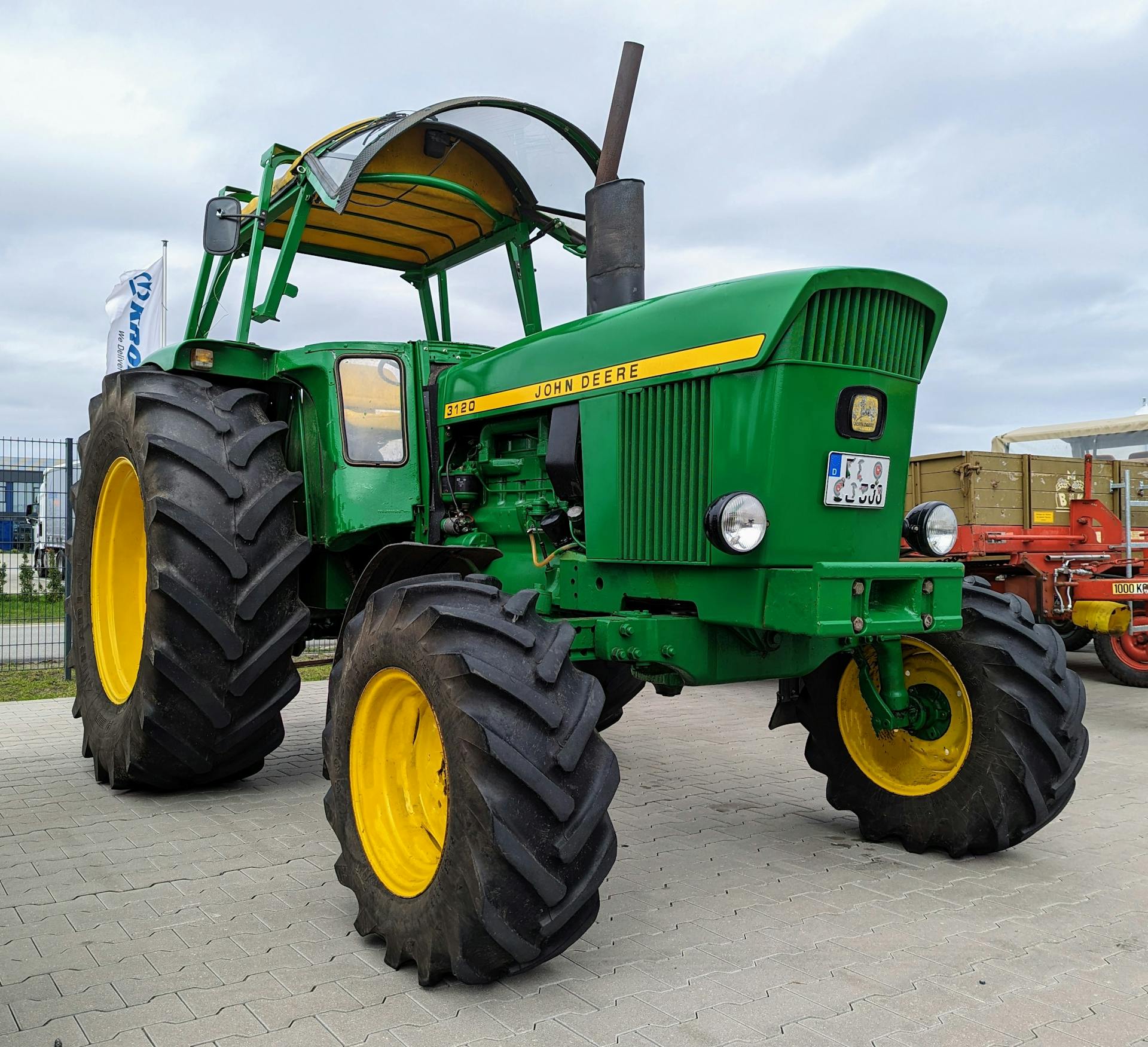 A classic John Deere tractor with large tires displayed outdoors in Werlte, Germany.