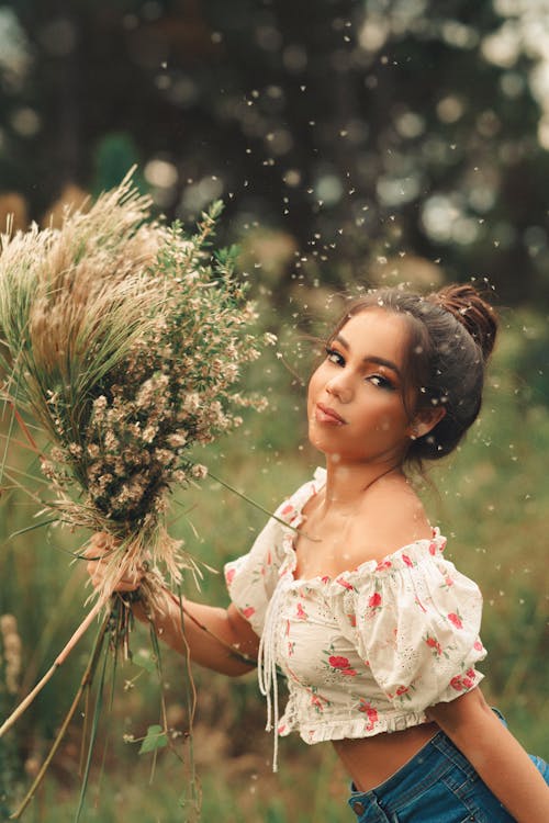 Woman Holding a Bouquet in a Meadow 