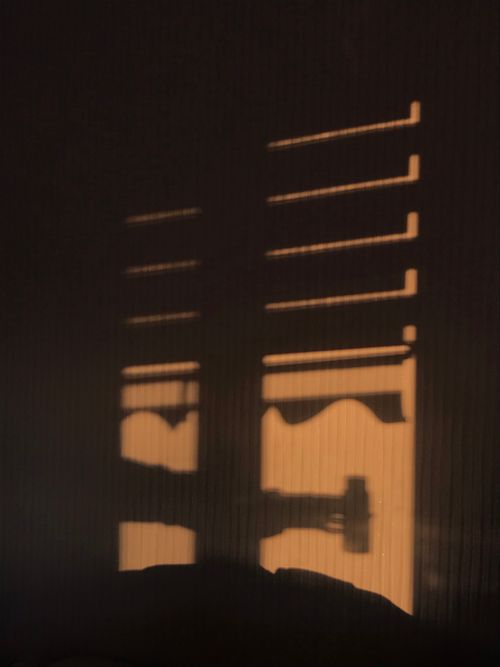 Free Abstract shadows from window shutters on a wall, creating a minimalist pattern. Stock Photo
