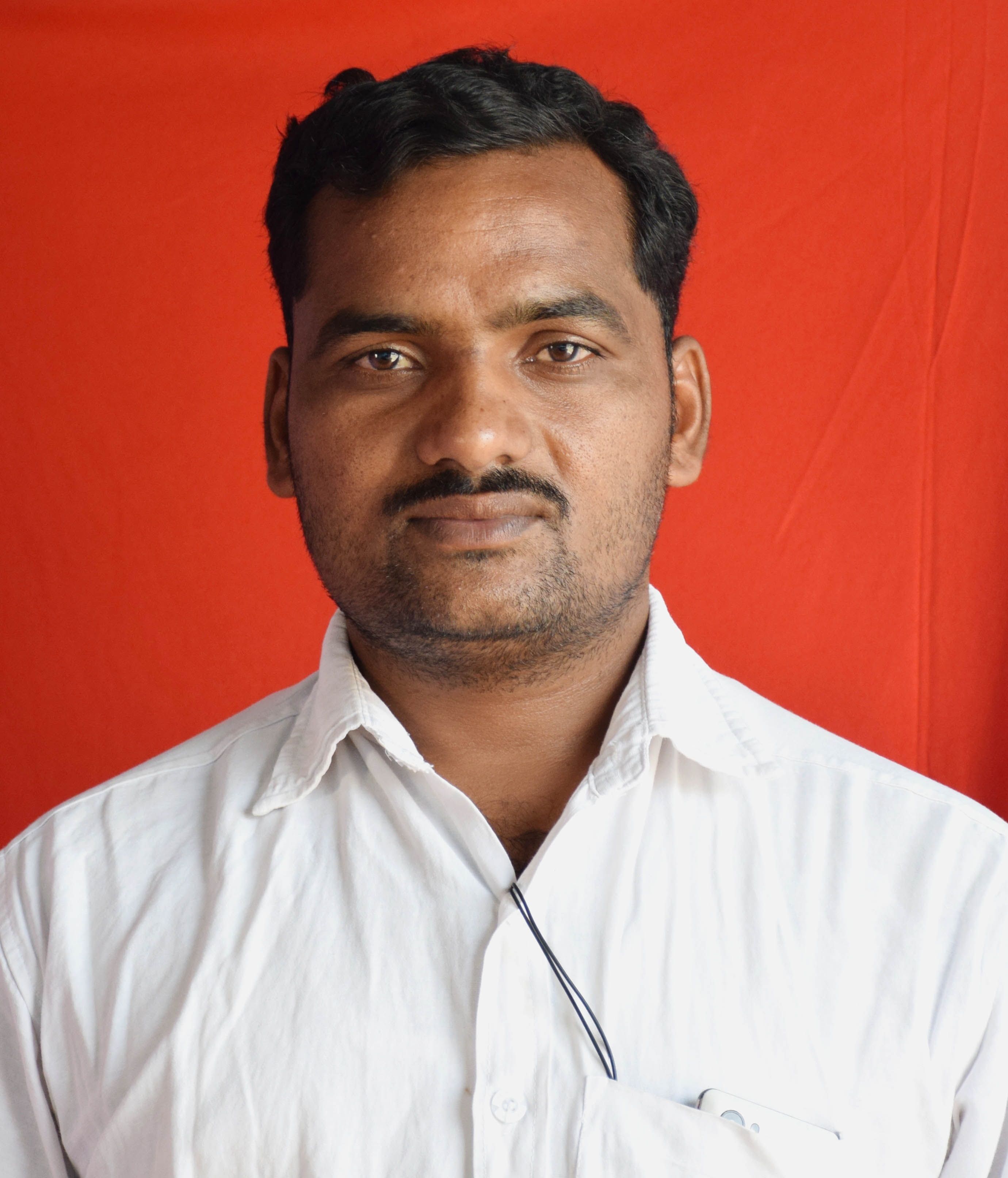 Portrait of a man in a white shirt with a red background. Fashion photography with a focus on expression.