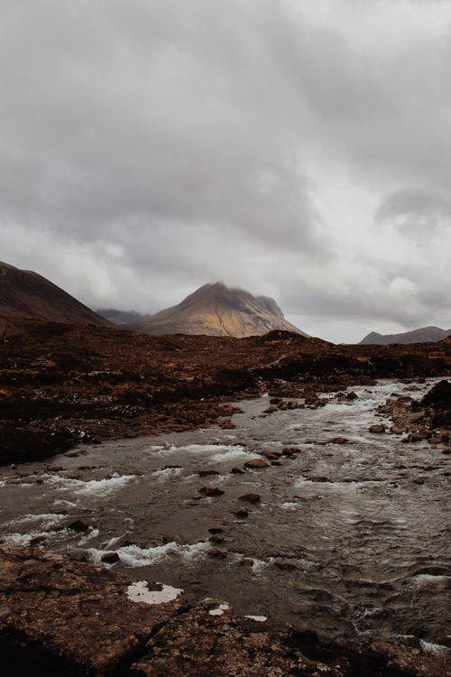 Free Capture of a moody Scottish Highland landscape featuring a flowing stream under overcast skies. Stock Photo