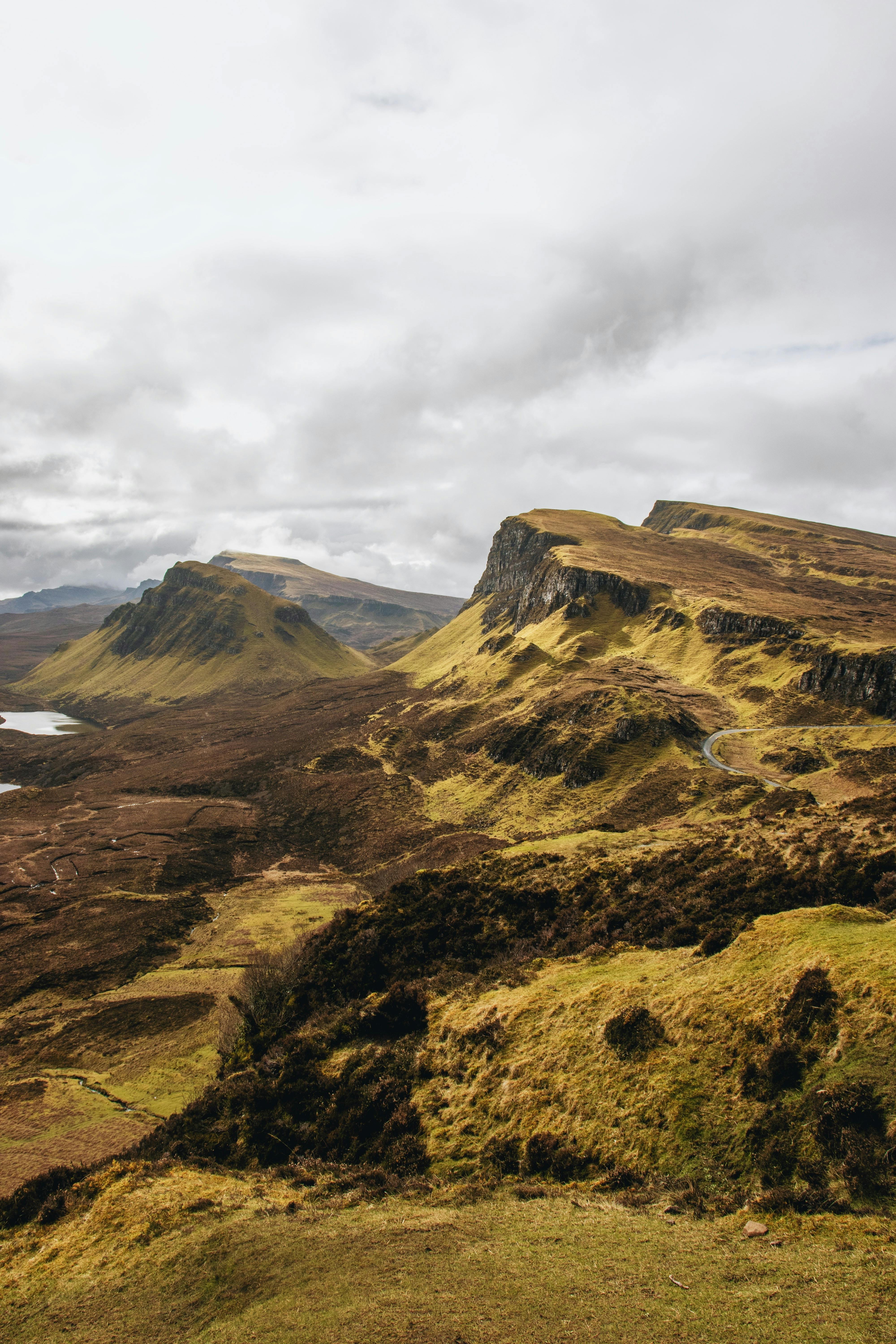 Explore the rugged beauty of the Scottish Highlands with an overcast sky and rolling hills during autumn.