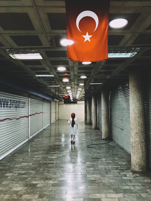 Girl Standing on Corridor with Turkish Flag