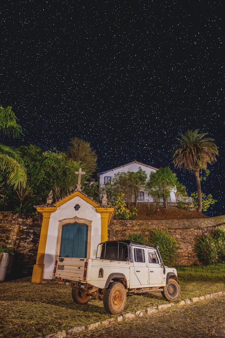 A Car In Front Of A Chapel In Ponte Seca In Ouro Preto, Brazil At Night 