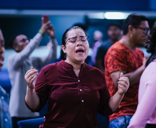 Free People engaged in passionate worship during a church service, expressing emotion and community spirit. Stock Photo
