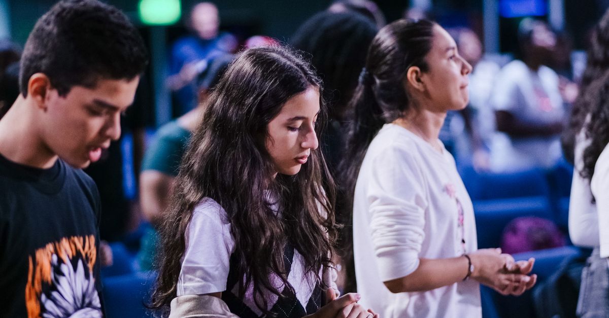 Small group of people praying together during Christ Embassy Ho midweek service