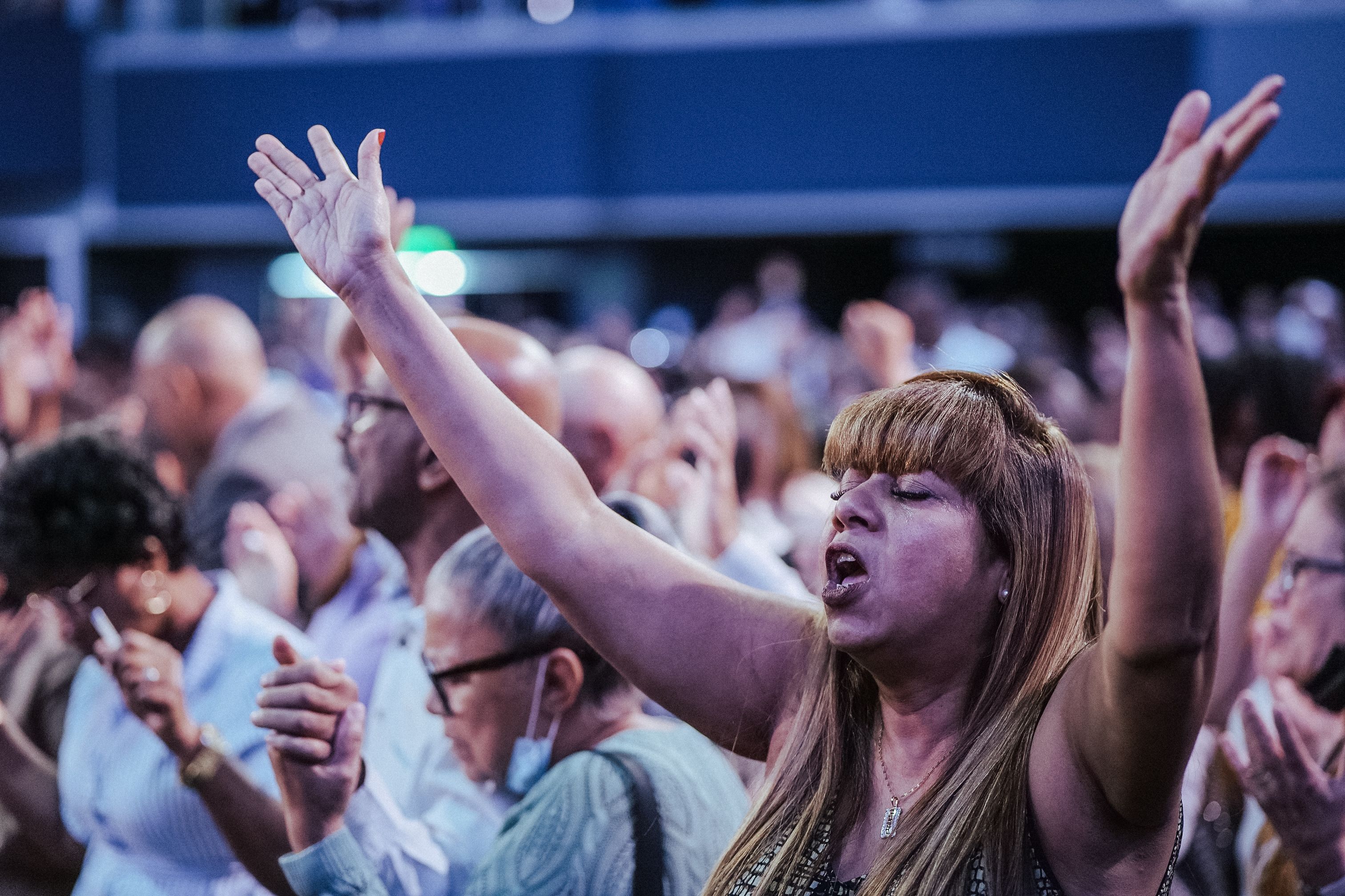 Congregation singing with hands raised in Christ Embassy Loveworld Arena Ho