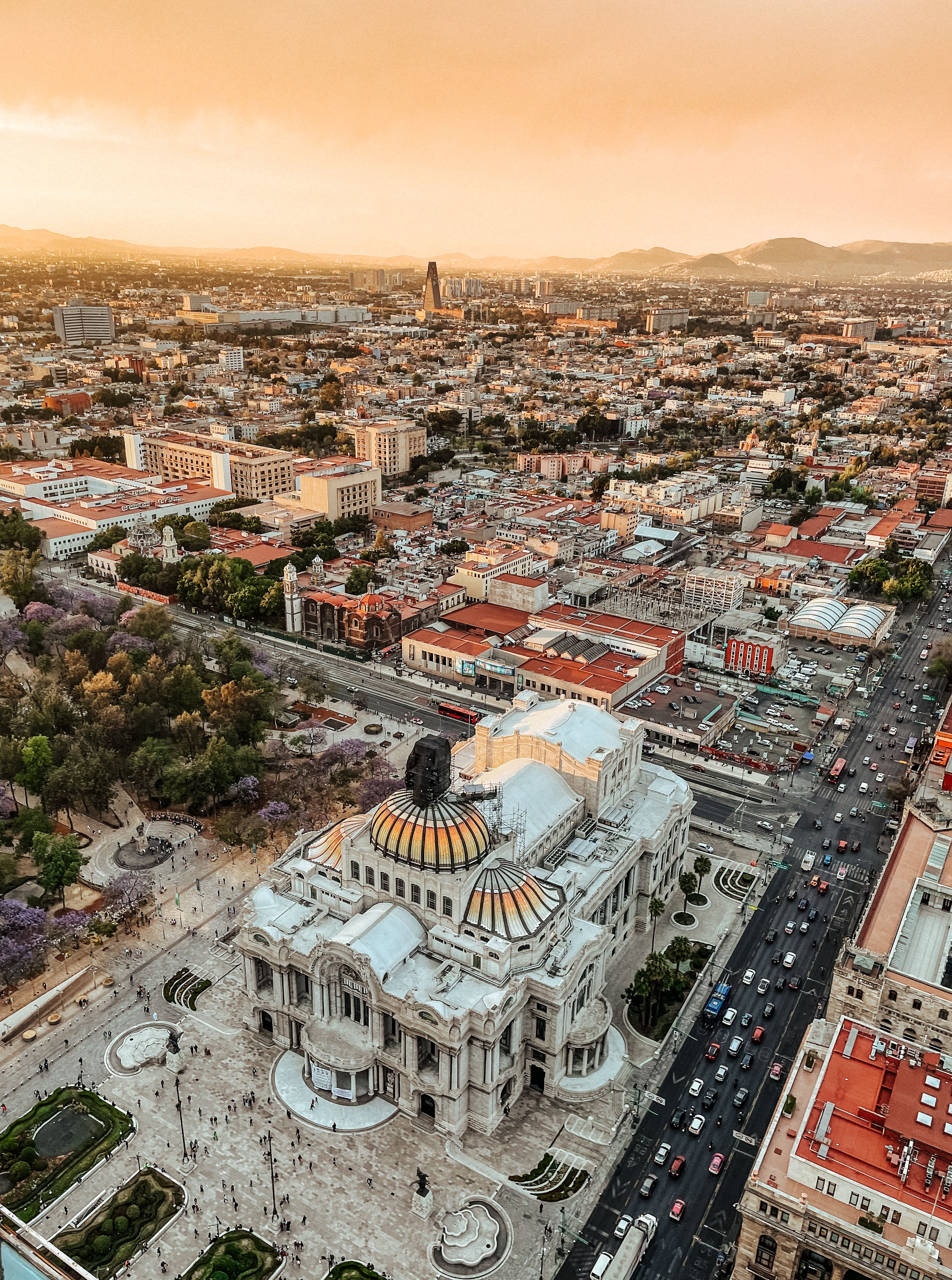 Explore the breathtaking aerial view of Mexico City and the iconic Palacio de Bellas Artes at sunset.