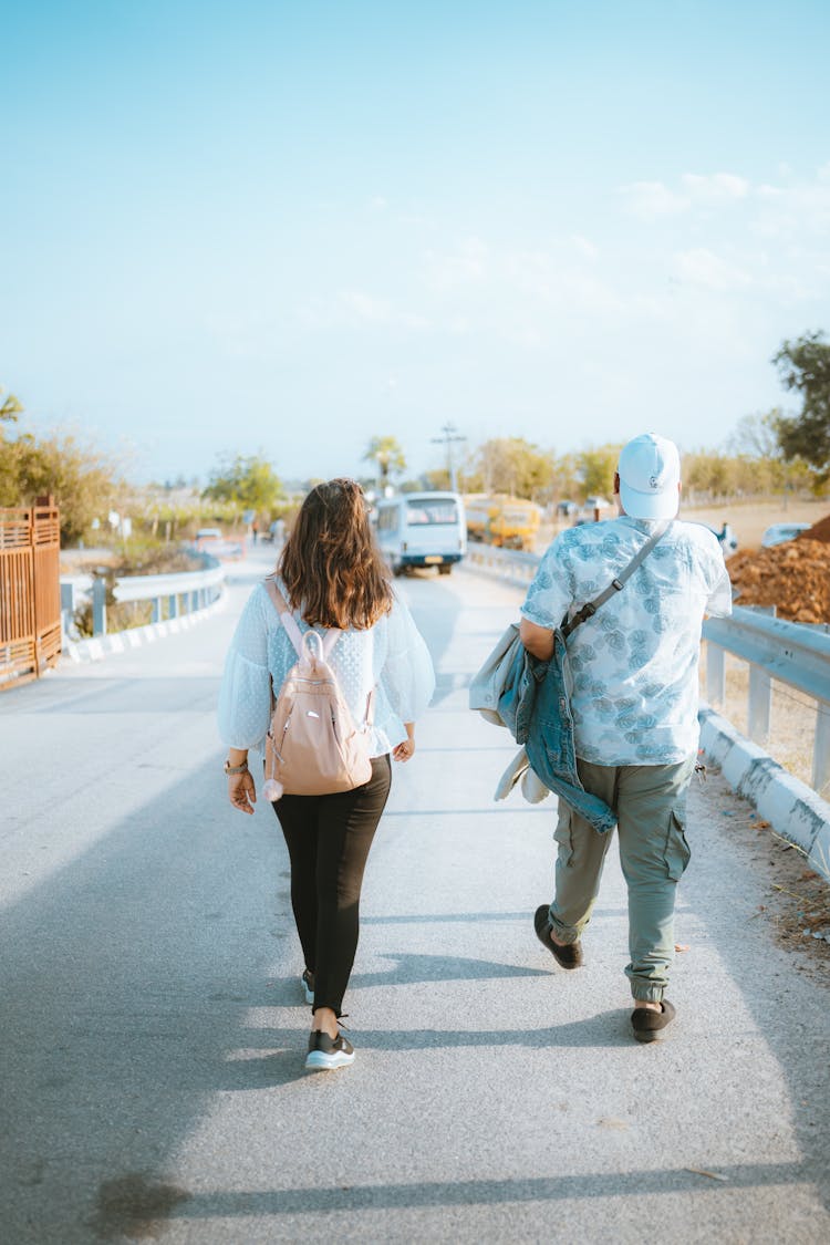 Man And Woman Walking Together On Street