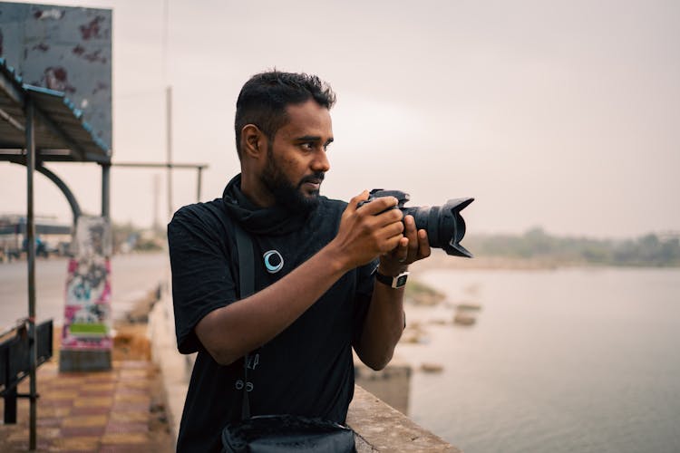 Man Taking A Photo On The Waterfront