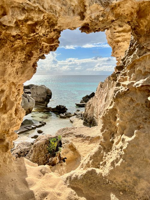Free Serene coastal view through eroded rocks in Ses Salines, Spain. Stock Photo