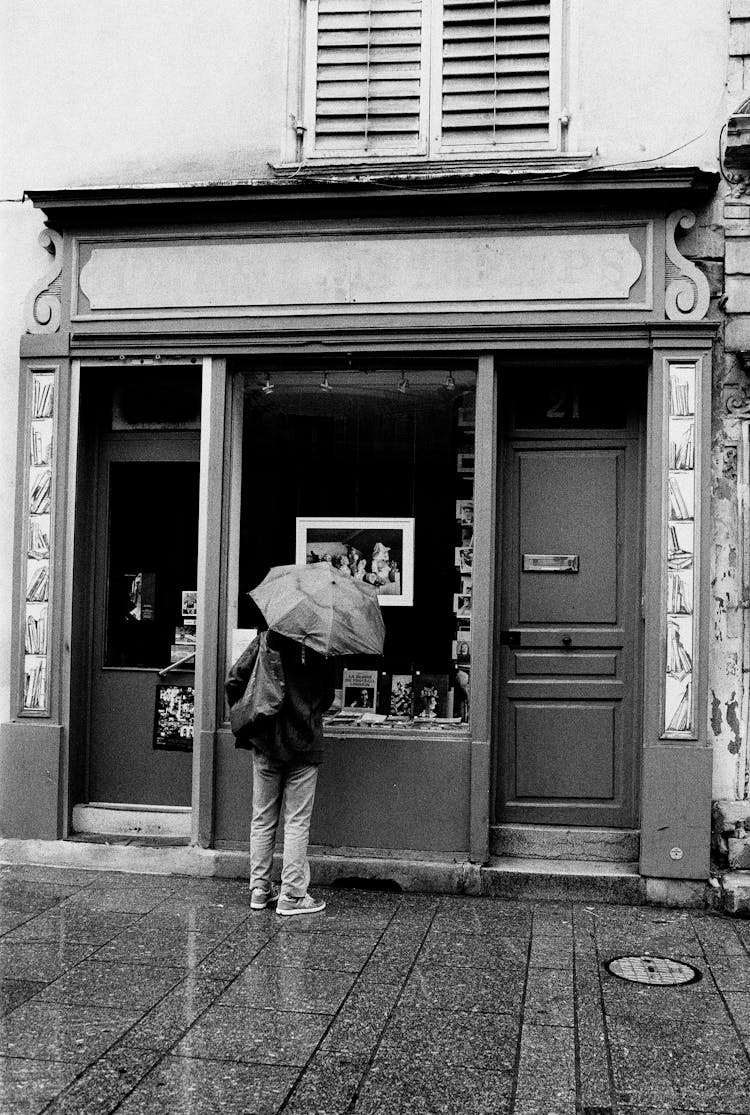 Person With Umbrella Window Shopping