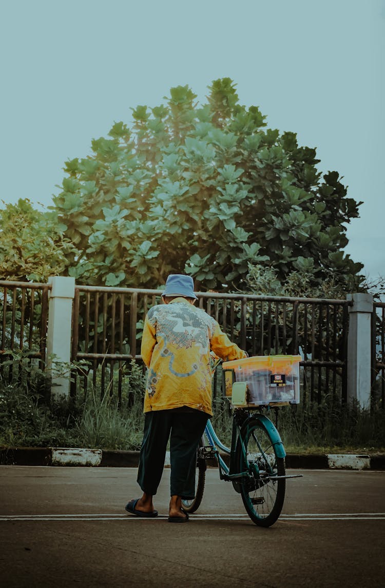 Elderly Person Holding A Bike